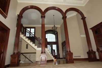 3-Two story Great Room with arched columns and entry foyer beyond