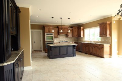 8-Kitchen with glazed maple cabinetry, painted island eating area, and wetbar.