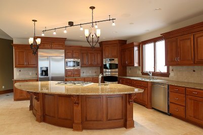 11-Kitchen with Cherry cabinets and granite countertops featuring semi-circular island & eating bar.