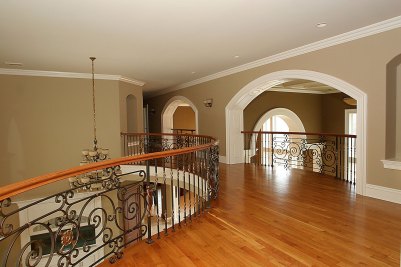 7-Second floor balcony with Cherry hardwood floor and wrought iron balustrade by Finelli Ironworks.