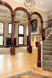 2-Two story entry foyer with Maple hardwood flooring and beamed Great Room beyond