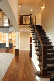 10-Open stairway to 2nd floor, Knotty Alder stained wood, wrought iron balustrade and decorative carpet runner