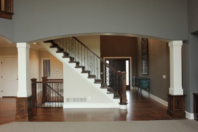 3-Front foyer entry, knotty alder stained stair newels & railing and knotty alder stained column bases on select Hickory hardwood floor