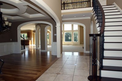 2-BF Castelvetro Salus Abano floor tile with Dark Emperador corner accents, Select Hickory hardwood, with arched openings and curved stairway.