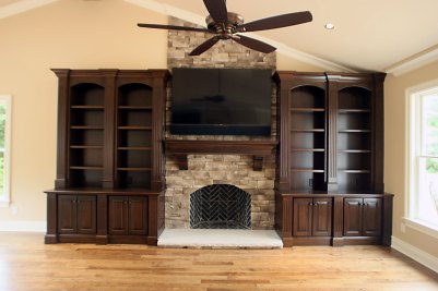 11-Cherry hearth room cabinetry surrounding fireplace with TV above